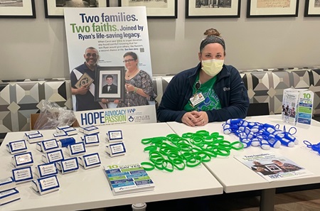 Diversion Prevention Specialist Kate DiMedio sits behind National Blue and Green Day table with flyers